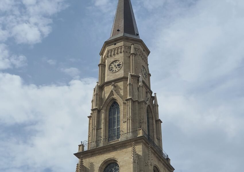 St. Michael's Church tower against a blue sky in Cluj-Napoca, Romania